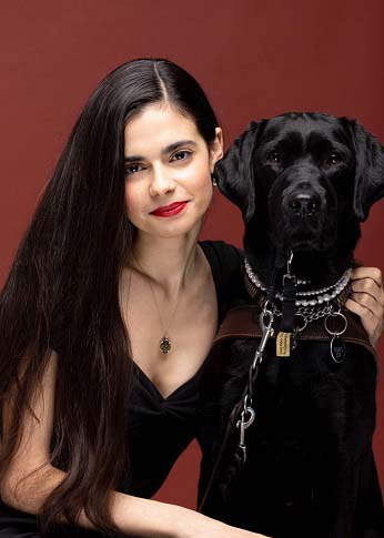 A Netflix publicity photo of Aria Mia and her black Lab guide dog. 